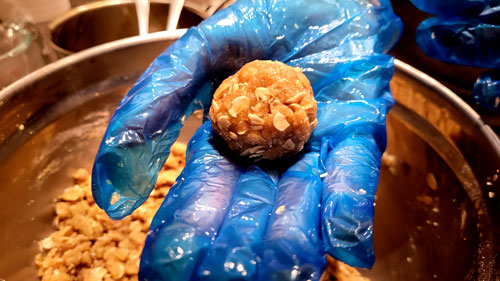 Forming the dough into balls for ANZAC biscuits