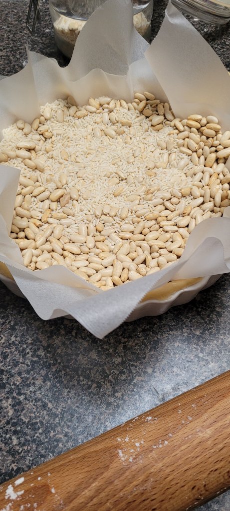 Pastry tart with rice and beans as pie weights