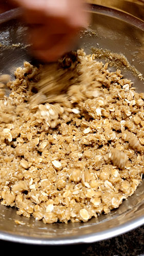 Mixing the melted butter, golden syrup and bicarb into the dry ingredients