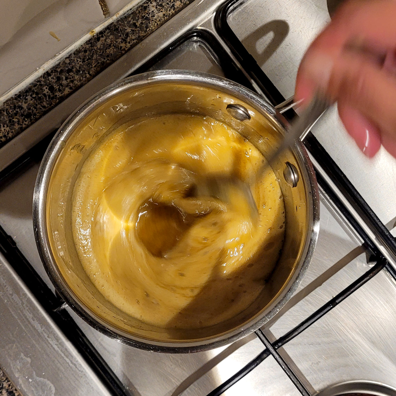 Adding the Bicarb to butter syrup mixture for ANZAC Biscuits